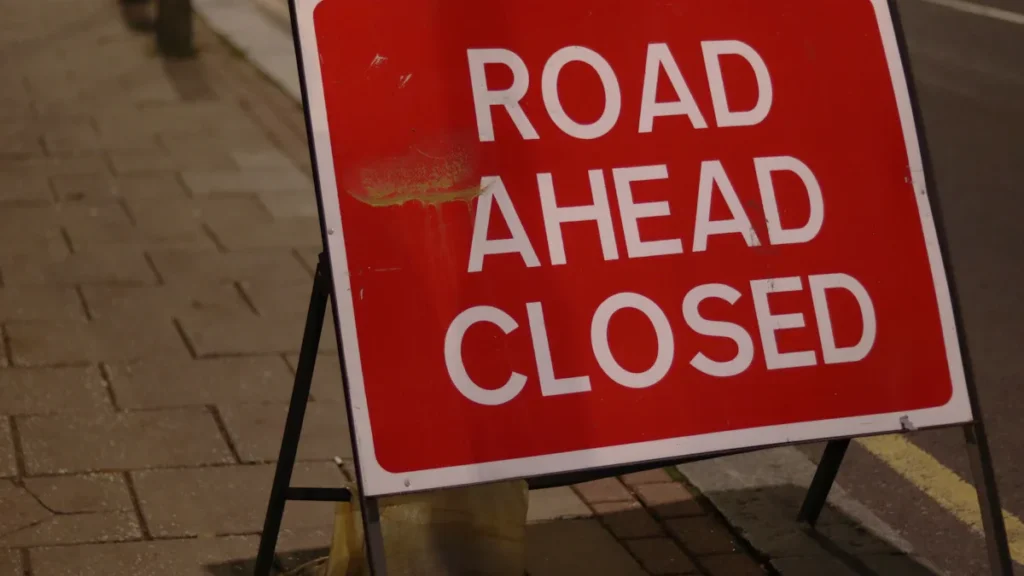 Red road ahead closed signage on a London street.
