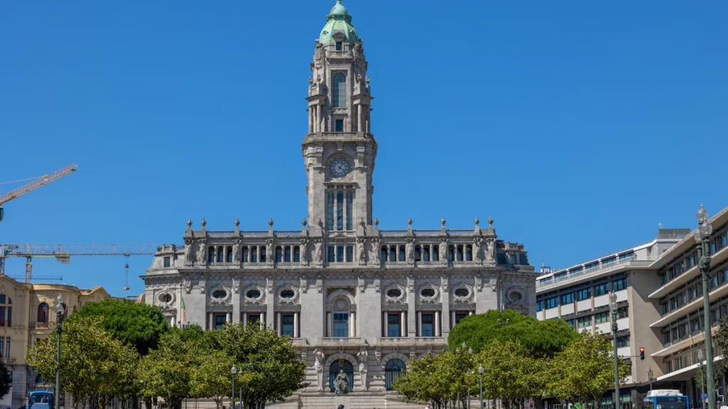 Grand historic civic building with a prominent clock tower in a European style city.