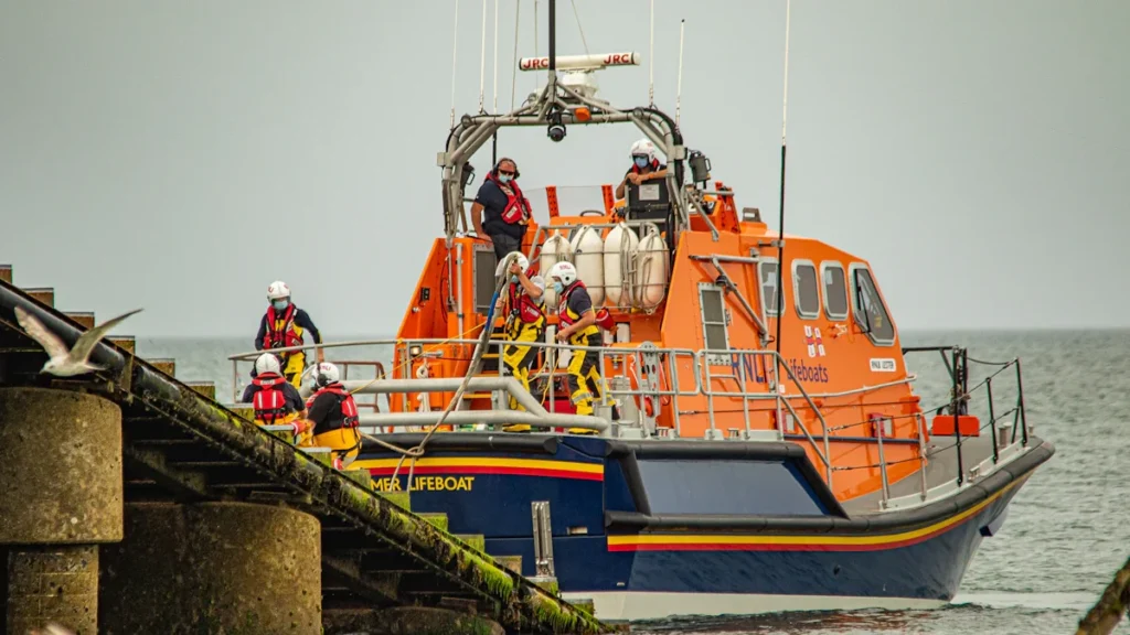 An RNLI lifeboat docking at the coast to support local community maritime activities.