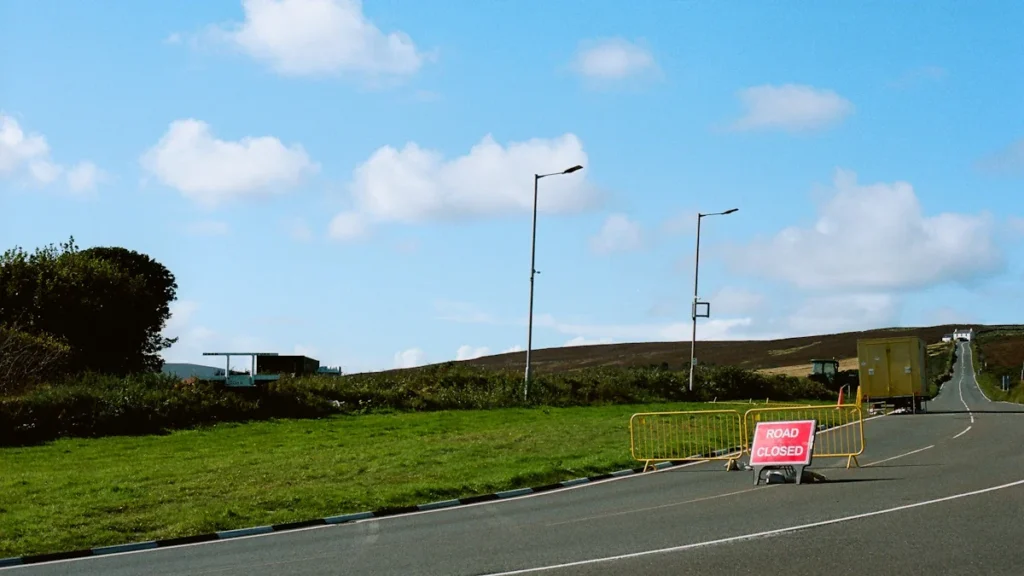 Road closure sign and yellow traffic barriers on the B5470 Macclesfield Road.