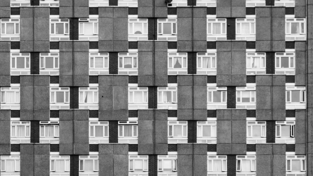 A black and white architectural detail of a repeating London residential apartment block.