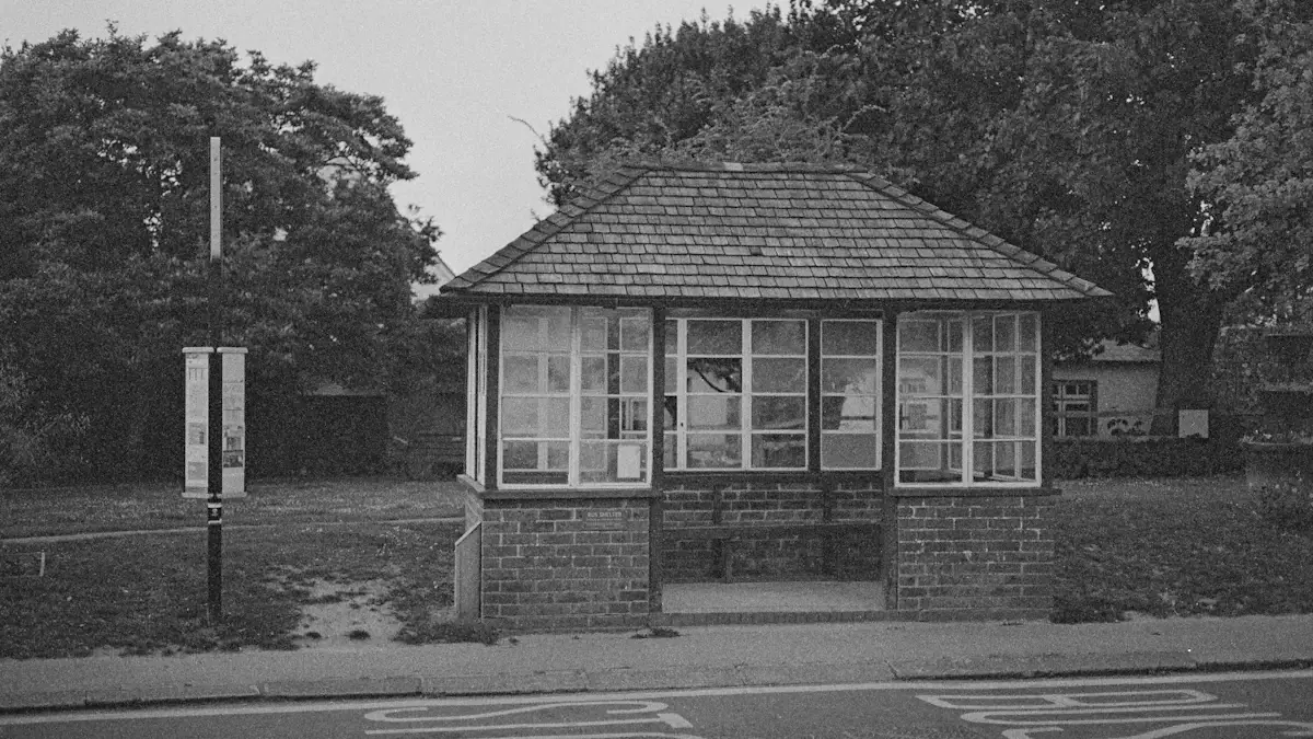 A traditional brick-built bus stop shelter beside a road in the United Kingdom.