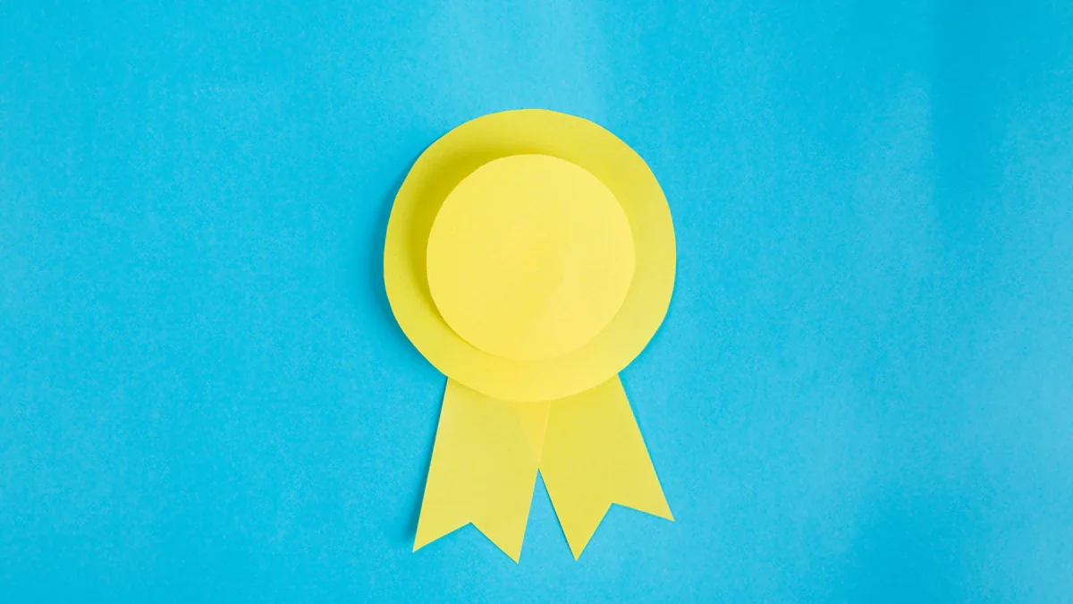 A yellow paper award ribbon on a bright blue background, minimalist style.