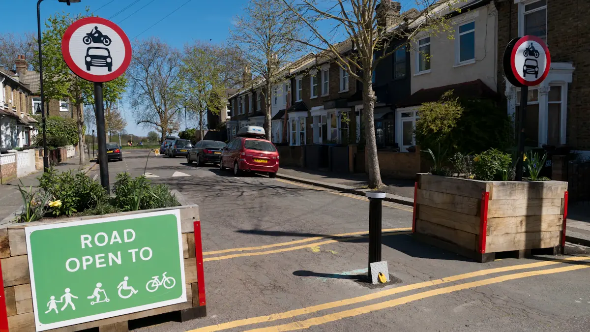 Street signage showing pedestrian and cycle priority in a residential UK neighborhood.