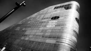 Striking low-angle view of the National Football Museum building exterior in black and white.