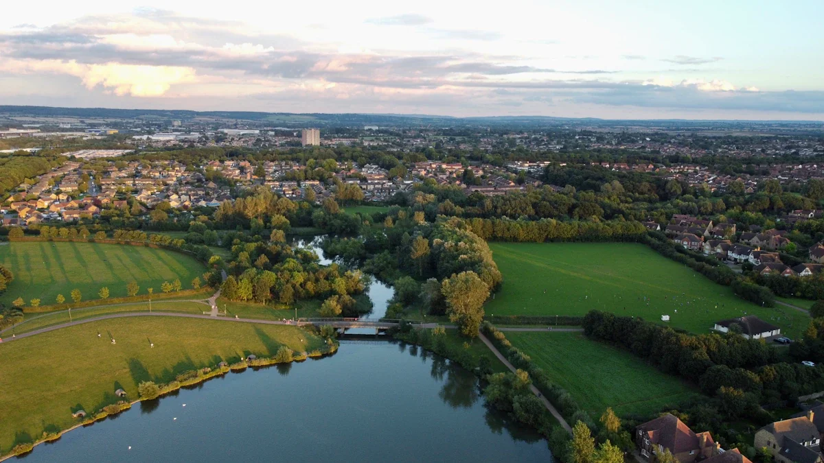 Aerial view of Furzton Lake and surrounding green landscapes in Milton Keynes at sunset.