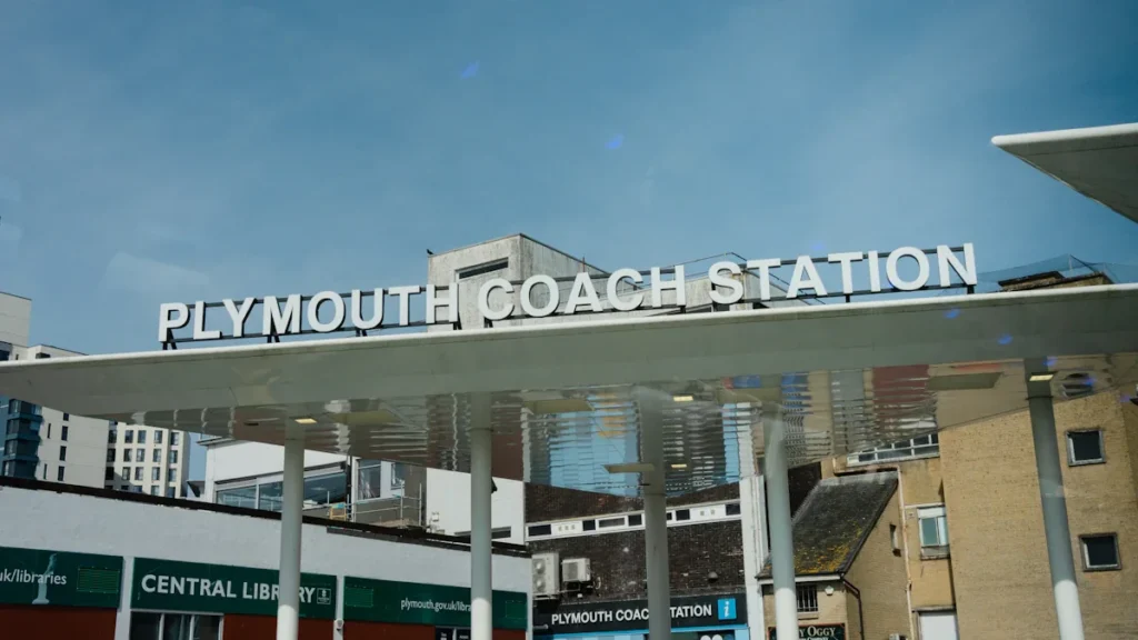 Exterior view of the Plymouth Coach Station building under a clear blue sky.