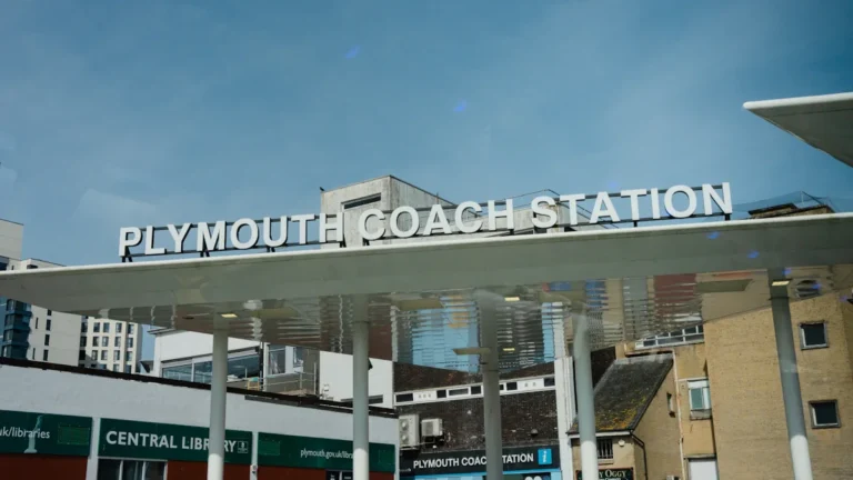 The exterior signage of Plymouth Coach Station on a clear sunny day.