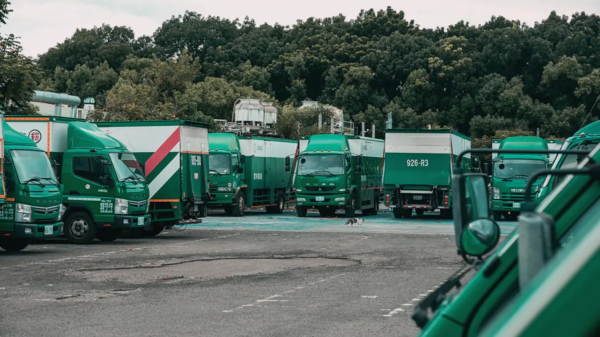 A fleet of green and white service trucks parked at a depot.