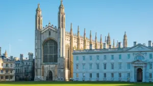 Iconic Cambridge University architecture featuring a historic stone building and green lawn.