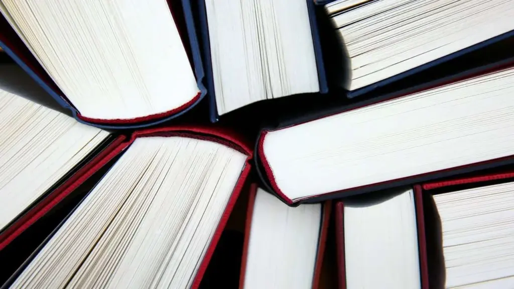 Top down view of several open hardcover books arranged in a circular pattern.