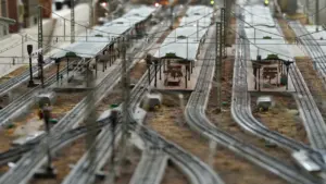 Detailed model railway station display with multiple tracks and platforms for exhibition.