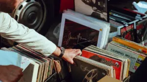 A person searching through a curated collection of vintage vinyl records.